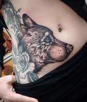 wilk i róże tatuaże na brzuchu