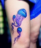 niebieskie meduzy tatuaże na udzie