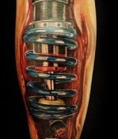 amortyzatory tatuaże na łydce